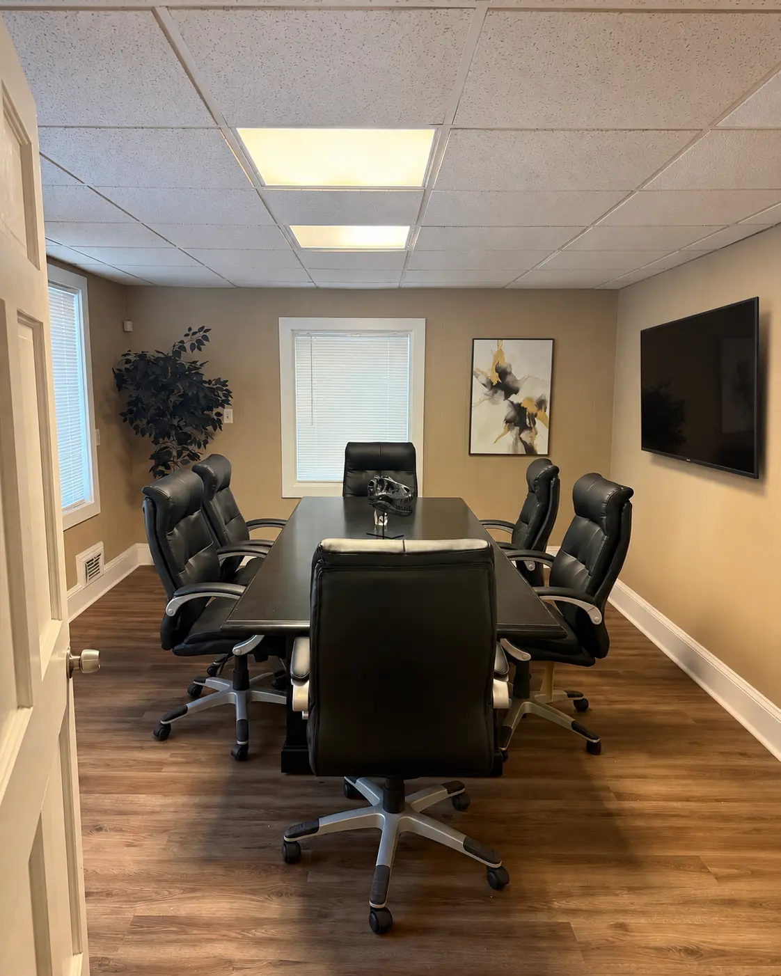 Executive meeting table seating six beneath warm lighting